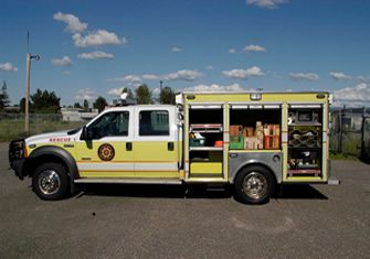Rescue 11, a white and yellow pickup-based rescue truck with open compartments